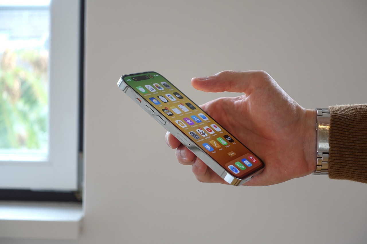 Apple iPhone displaying the Spotlight search bar with iOS 27 performance issues highlighted