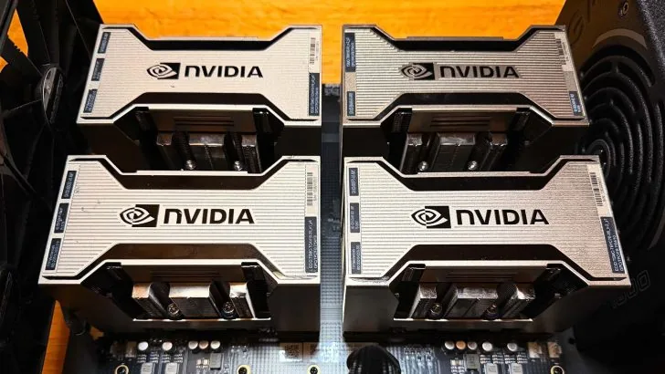 Four Tesla V100 GPUs mounted on an NVLink carrier board for an AI benchmark test comparing performance against the M5 Ultra.